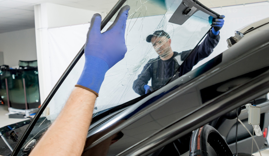 image of guys performing glass repair of car